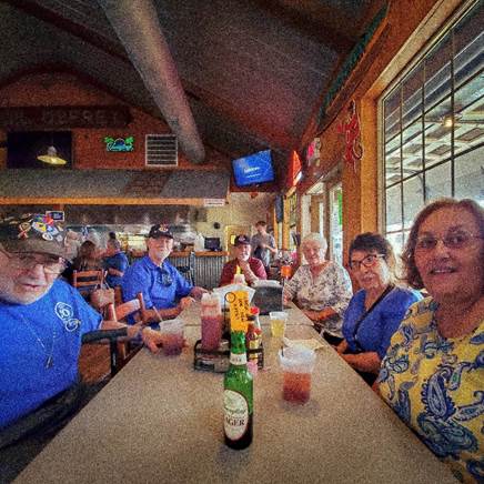 A group of people sitting at a table

Description automatically generated with medium confidence