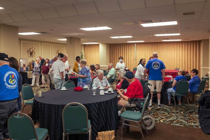 A group of people in a room

Description automatically generated with medium confidence