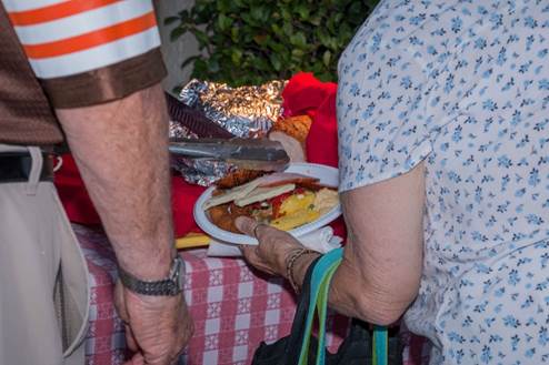 A person holding a plate of food

Description automatically generated with medium confidence