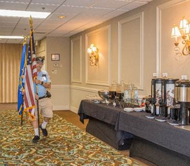 A person holding a flag

Description automatically generated